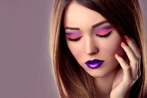 Bright Colour Fashion Makeup. Trendy Girl Face Closeup. Pink Eyeshadow and Violet Lipstick.