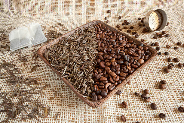 dried tea leaves and roasted coffee beans: theine vs caffeine stock photo