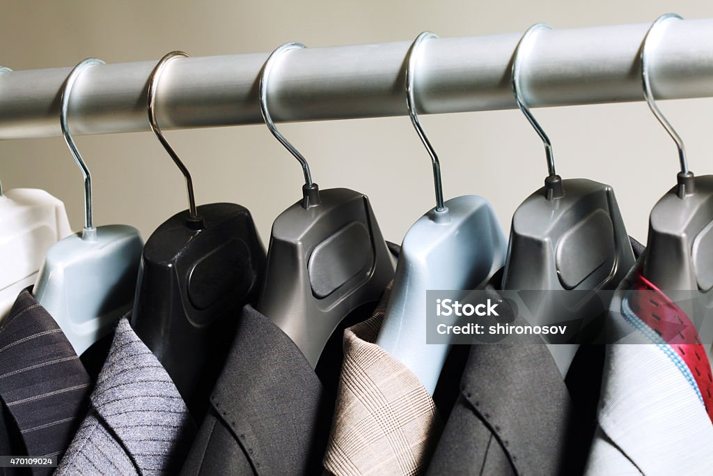 Hangers with suits Photo of hangers with jackets on them in boutique 2015 Stock Photo