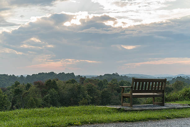 istock Wood bench facing the mountains and sunset 470111712