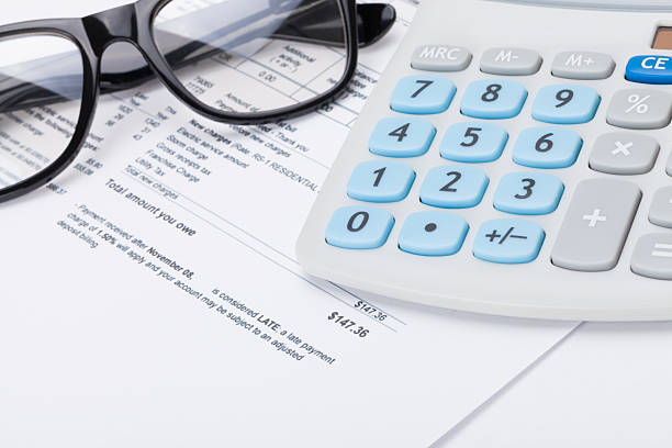 istock Black glasses and calculator over utility bill 470111828