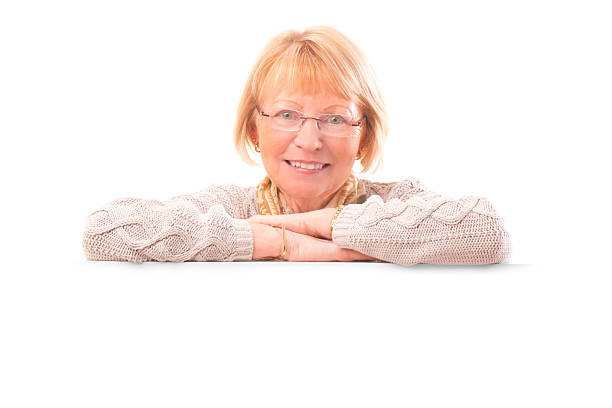 istock senior female with blank banner 470116065