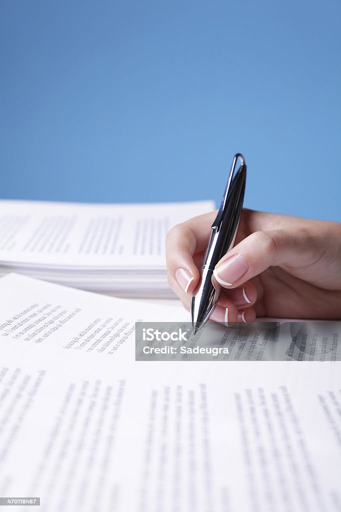 Paperwork Unrecognizable person reviewing a text.  (Shallow Depth of Field - Focus on pen).  Generic Text: "Lorem Ipsum..." Proofreading Stock Photo
