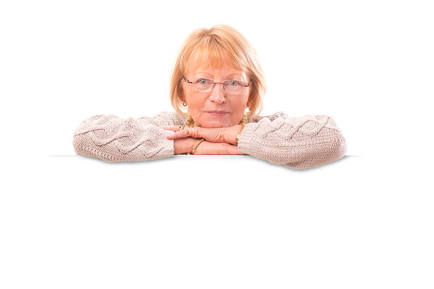 istock senior female with blank banner 470118805