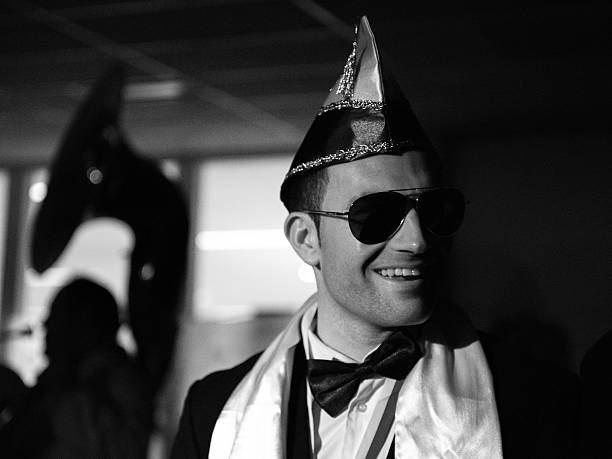 Black & White photograph of a smiling man,  celebrating carnival in the south of the Netherlands 