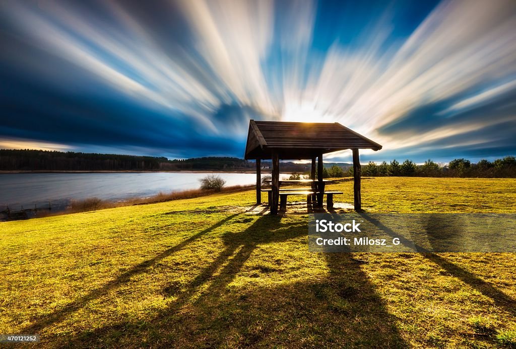 Landscape with wooden hut. Long exposure photo. Beautiful landscape of wooden hut under dramatic sky photographed on long exposure. Landscape with bad weather and vibrant colors. 2015 Stock Photo