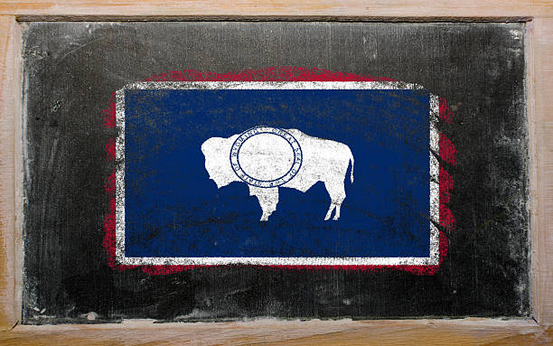 istock flag of wyoming on black blackboard 470125208