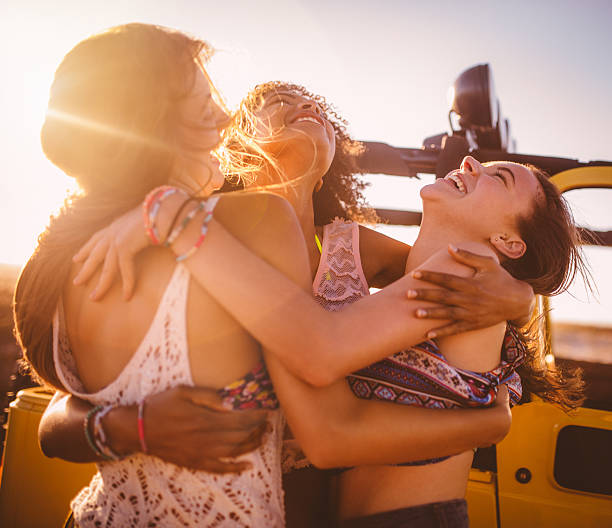 istock Friends hugging while on a road trip together 470134630