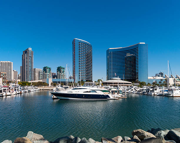 View of Downtown San Diego California from Coronado Bridge during golden hour with boats in the bay. United States of America famous city skyline