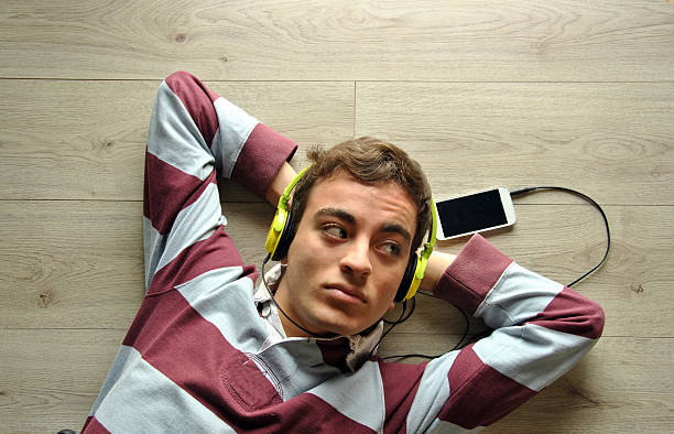 istock Young man listening to music 470137636
