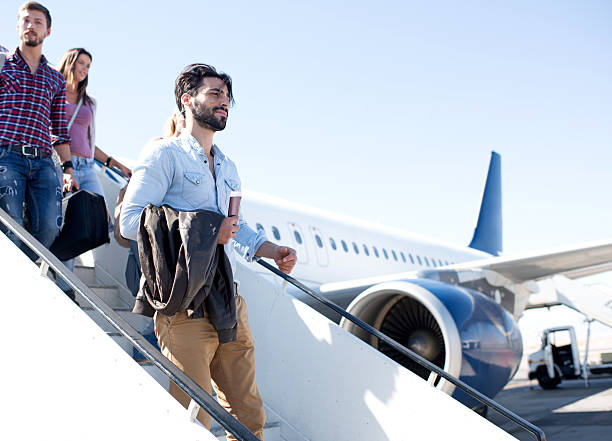 istock Young passengers getting out of the airplane. 470137728