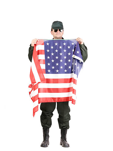 istock Man in workwear stands with american flag. 470139193