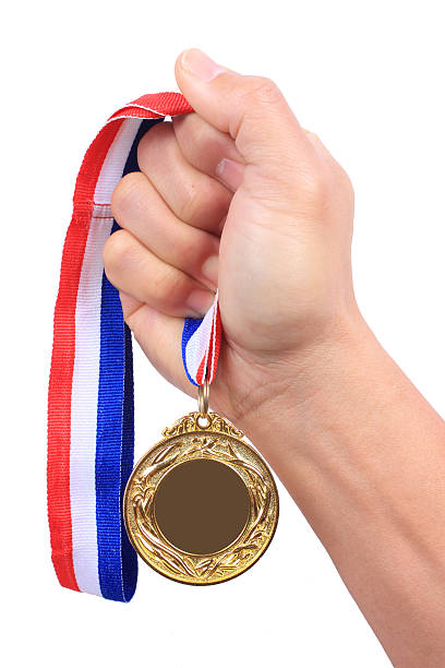 istock Male hand holding gold medal 470144922