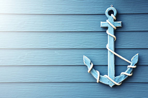 Anchor on blue wooden background. Beautiful anchor on blue wooden background. anchored photos stock pictures, royalty-free photos & images