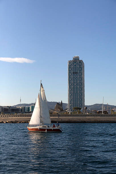 Barcelona - Veil boat passing by Barceloneta beach stock photo