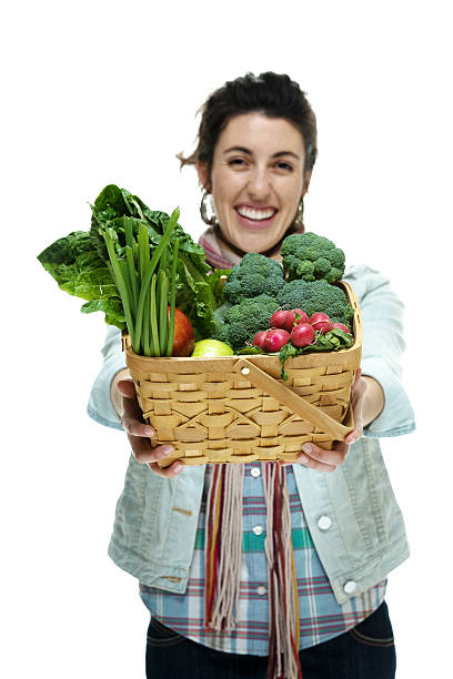 istock Smiling woman holding vegetable basket 470145197