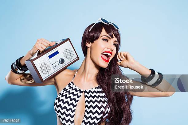 Excited Young Woman Wearing Swimsuit Listening To The Radio Stock Photo - Download Image Now