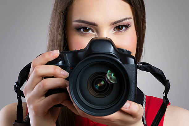 istock Cheerful woman holding photo camera 470148642