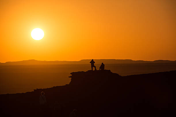 istock People at sunset on top of a desert mountain 470148924
