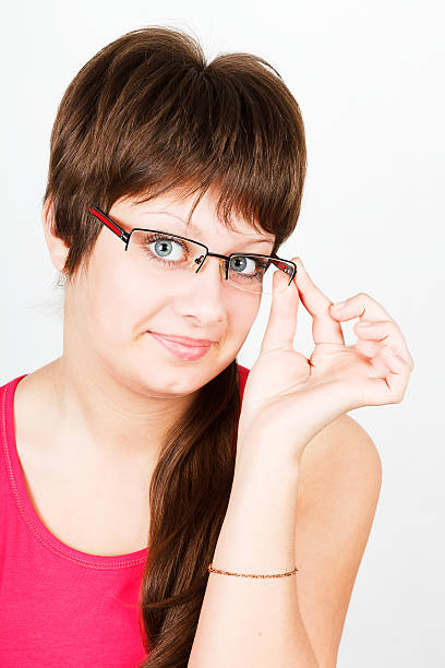 Young attractive blue-eyed girl in glasses stock photo