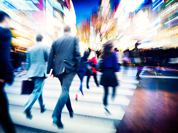 istock Blurred business people walking in a brightly lit city 470148978