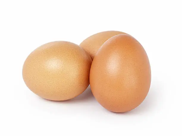 Photo of three brown eggs isolated