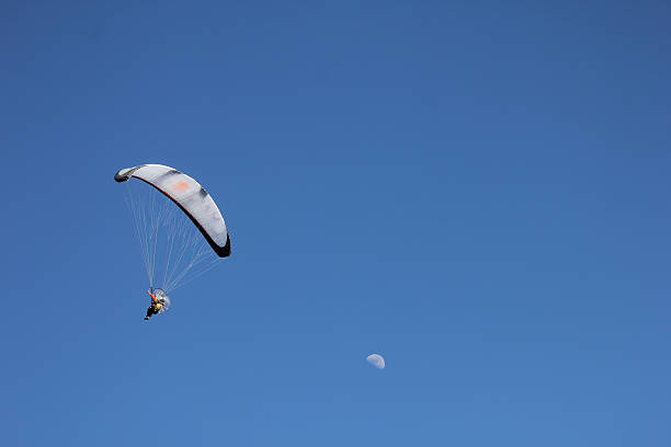 istock flying paraglider near the moon 470153286