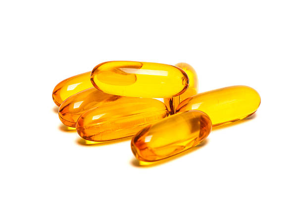 istock Fish oil supplement product capsules isolated on white 470156084