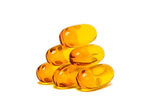 istock Fish oil supplement product capsules isolated on white 470156132