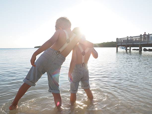 istock Boys Playing In Ocean Together 470156720