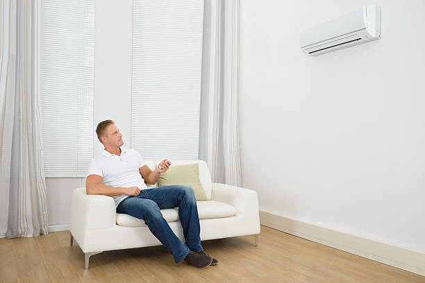 istock Man Adjusting The Temperature Of Air Conditioner 470156864