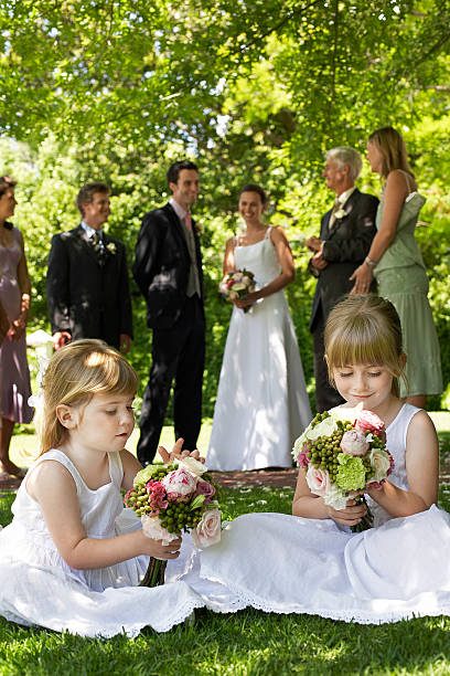 istock Cute Little Bridesmaids Holding Bouquets In Lawn 470157207