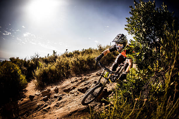 istock Mountain biker speeding round a corner on a dirt road 470158658
