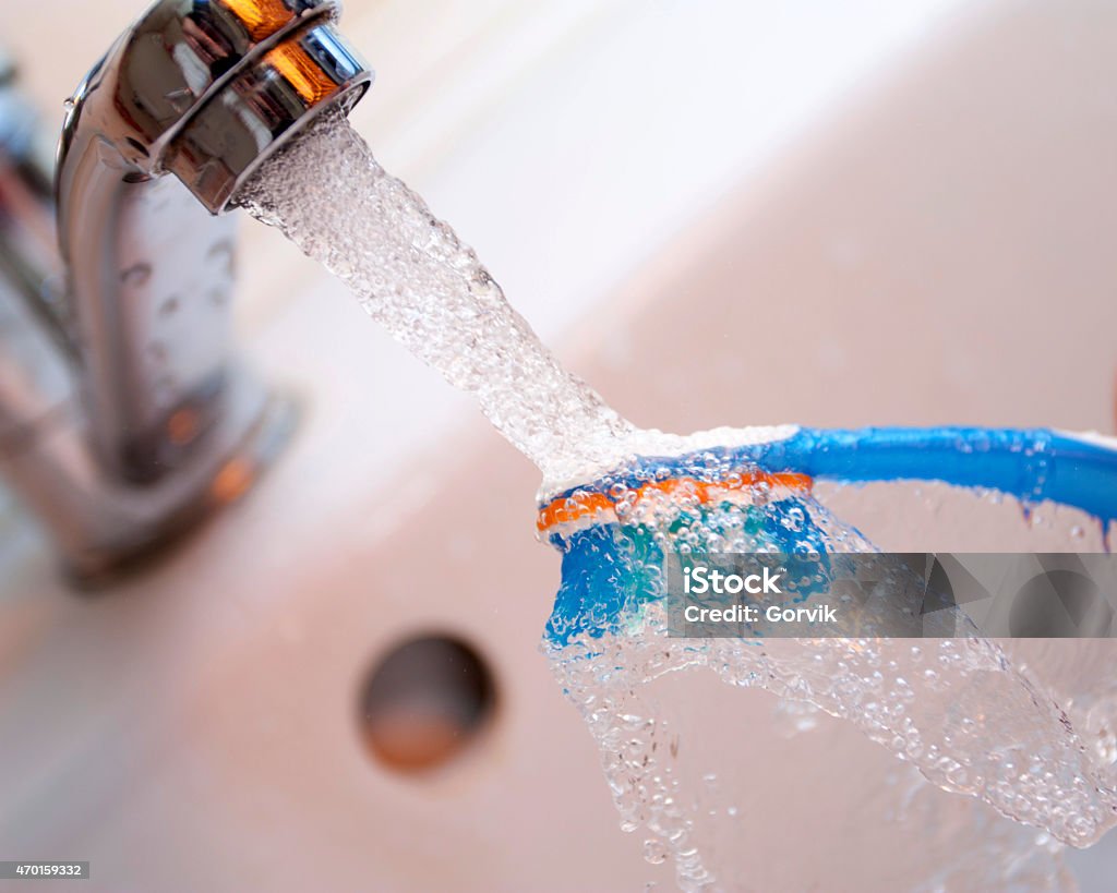 Tooth-brush washing Tooth-brush washing under the crane with water 2015 Stock Photo