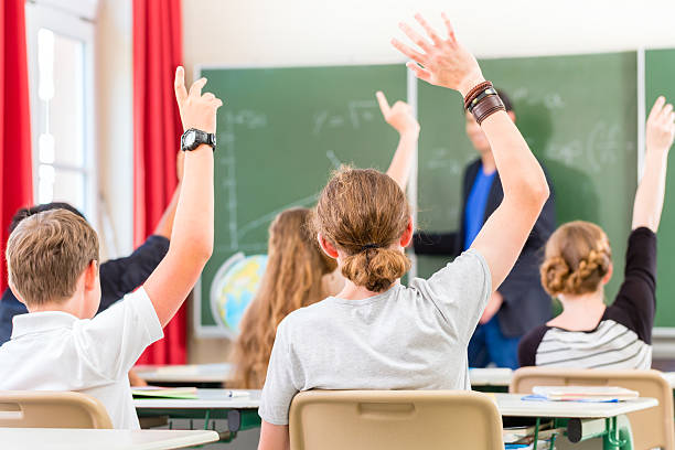 istock Teacher  teaching class of  pupils in school 470159492