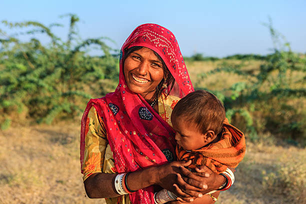 istock Young Indian woman holding her child 470162780