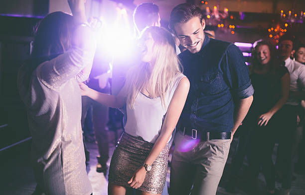 istock Couple enjoying a fun night out dancing with friends 470163150