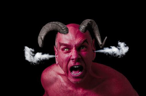 Man pissed off with red skin and horns