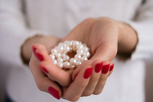 istock Pearls in female hands 470163750