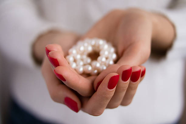 istock Pearls in female hands 470163756