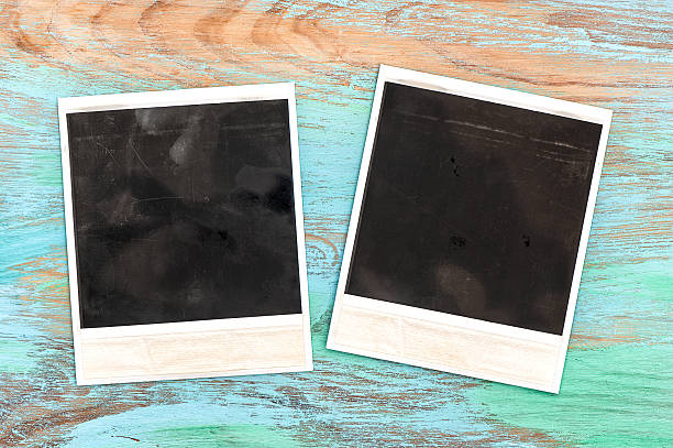 istock Vintage style photo frames over rustic wooden background 470164378