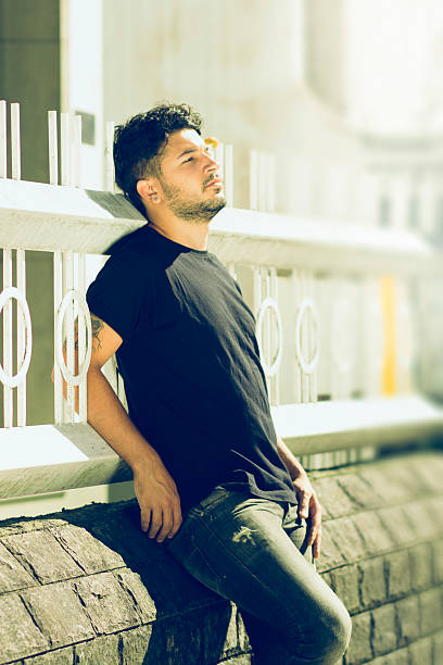 istock Young man leaning on fence sunning 470167459