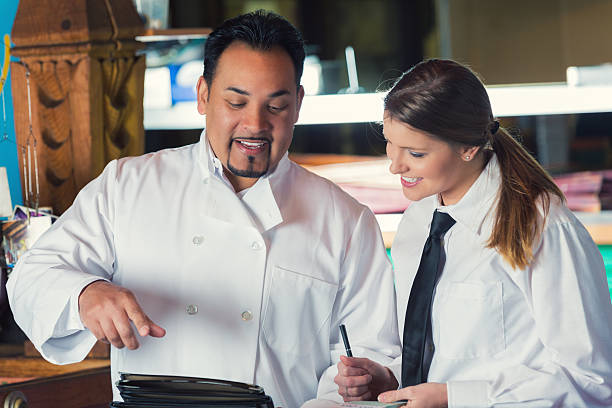 istock Chef and waitress reviewing menu in casual dining restaurant 470167482