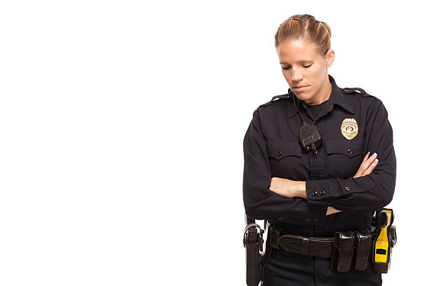 Portrait of a mature male law enforcement officer (highway patrol, sheriff, or park ranger) pointing at the viewer. Isolated on a pure white background.