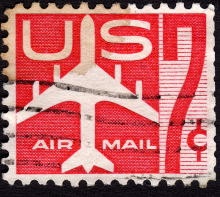 United States postage stamp 1960 in the value of 7c used for overseas air mail deliveries showing air mail symbols and the print Air Mail