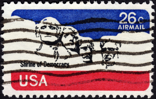 United States postage stamp 1974 in the value of 26c showing former presidents' heads at Mount Rushmore and the print 'Shrine of Democracy'