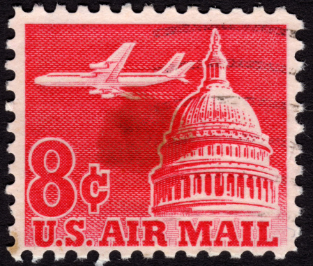 United States postage stamp 1963 in the value of 8c used for overseas air mail deliveries showing  a jet flying over the Capitol building