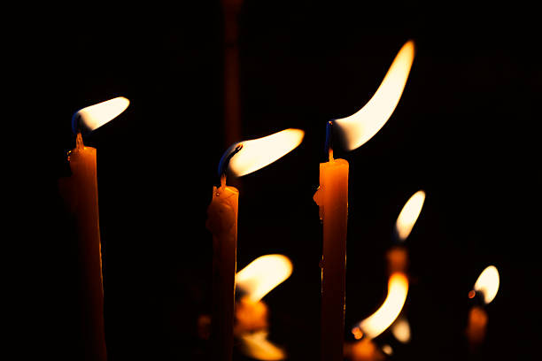istock Burning candles in a church on a dark background 470171648