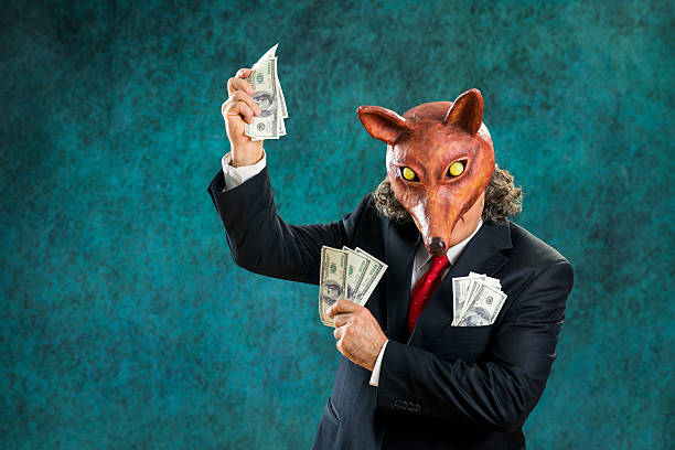 istock Rich business man wearing fox mask holding  banknotes 470172565