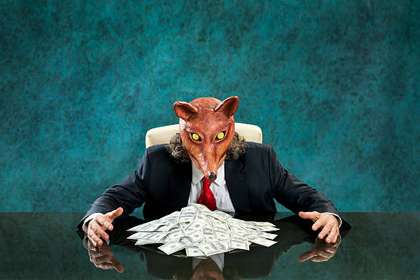 istock Rich business man wearing fox mask with stack of banknotes 470172567